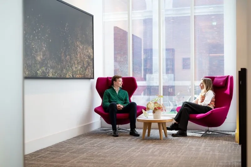 two individuals talking on couches